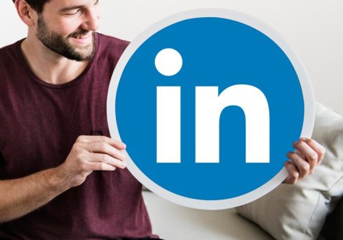 person-holding-linkedin-icon_53876-65402